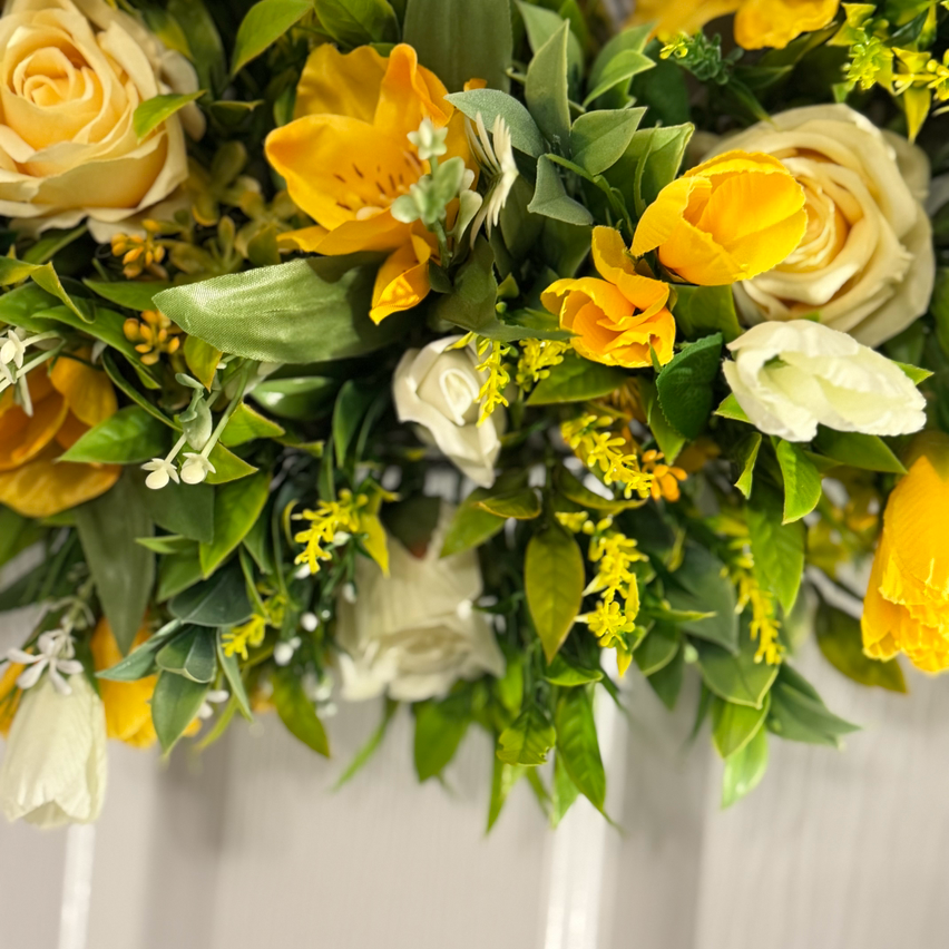 Lemon rose with yellow/white crocus, ivory rose buds and foliage wreath