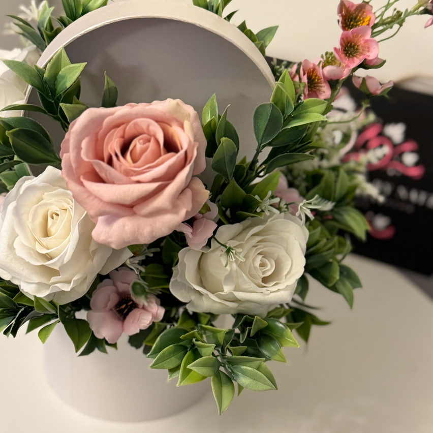 Luxury velvet touch white and vintage pink roses with foliage floral hat box arrangement