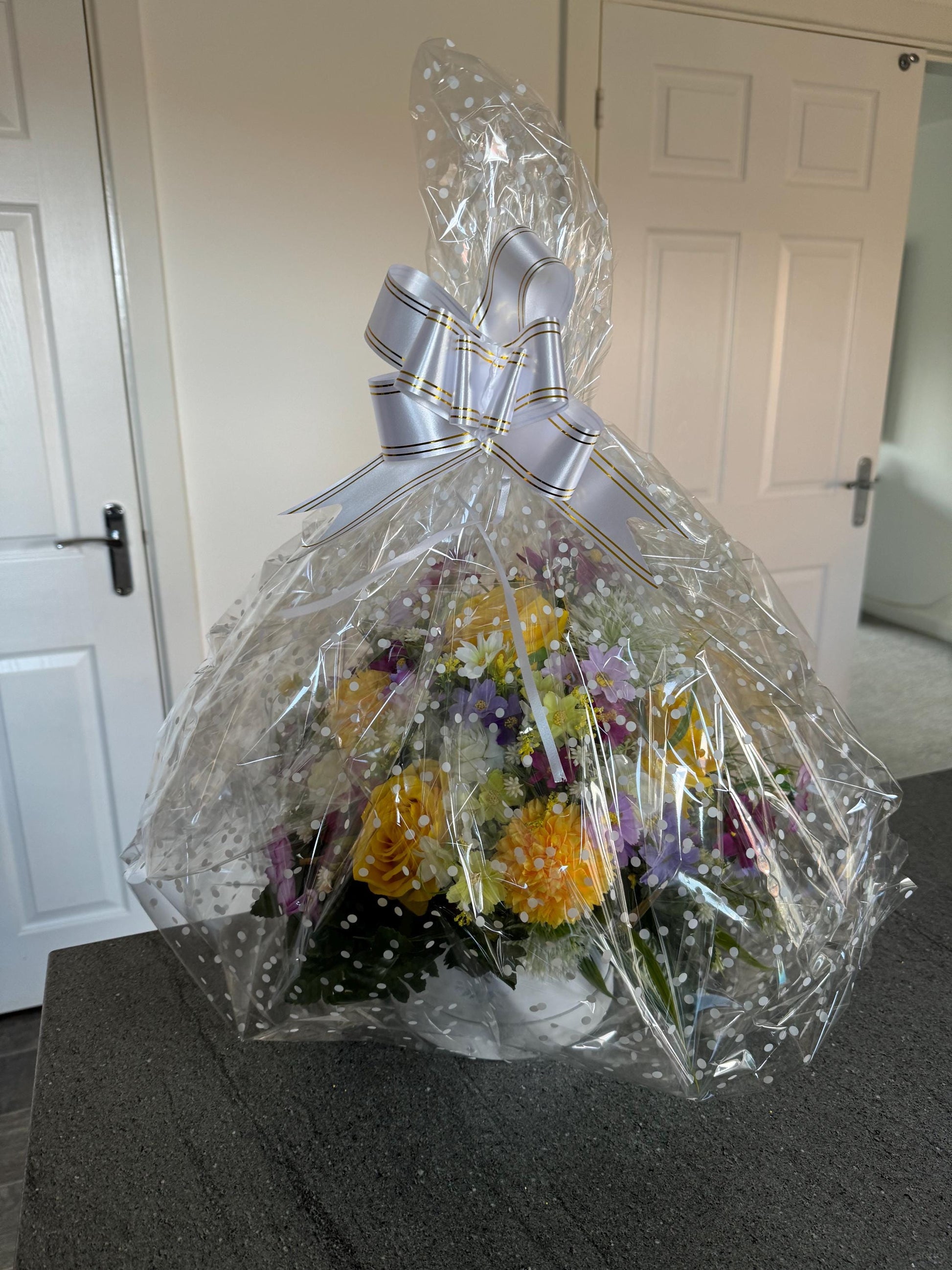 Unique, handmade floral White Lilly hatbox arrangement filled with artificial greenery, flowers and yellow roses.