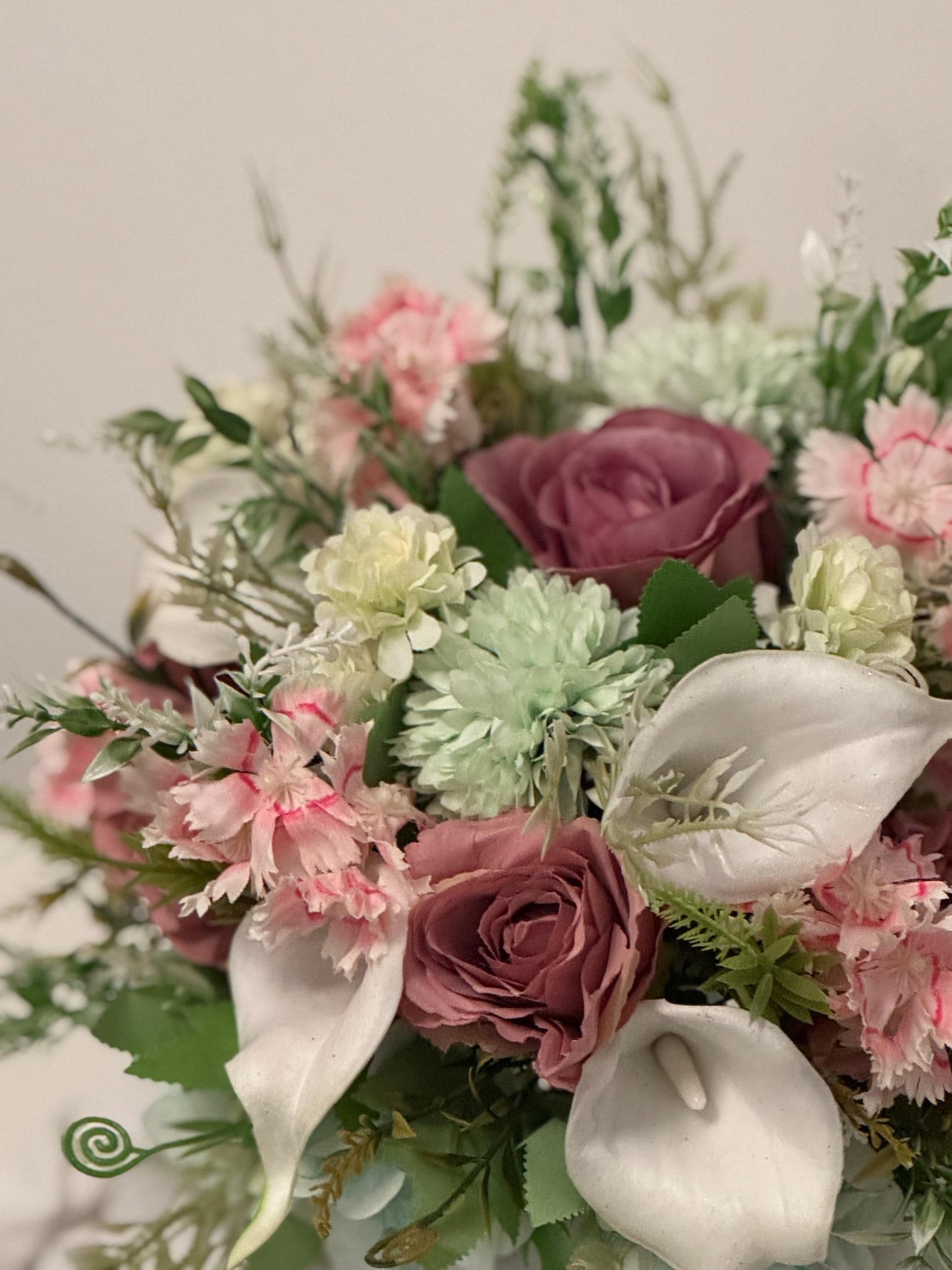 Artificial wedding bridal bouquet with blush pink roses, ivory lilies, sage green spikey chrysanthemums and foliage