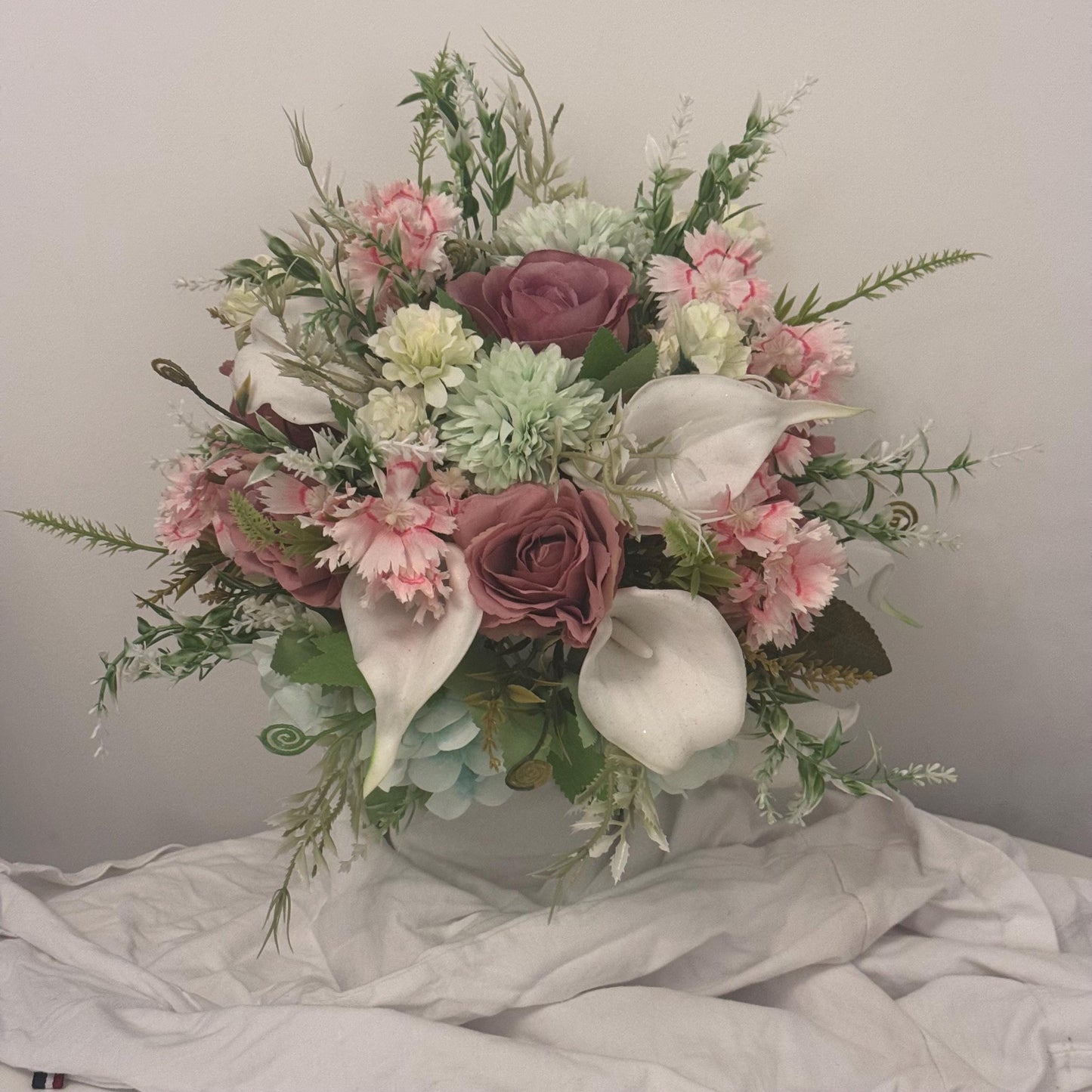 Artificial wedding bridal bouquet with blush pink roses, ivory lilies, sage green spikey chrysanthemums and foliage