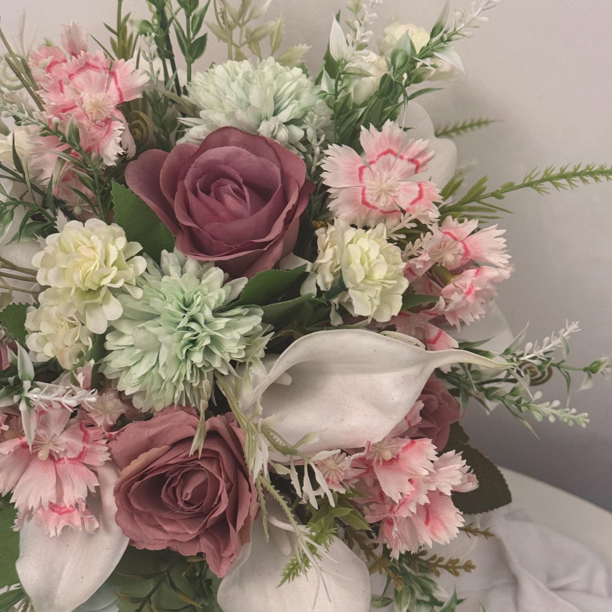 Artificial wedding bridal bouquet with blush pink roses, ivory lilies, sage green spikey chrysanthemums and foliage