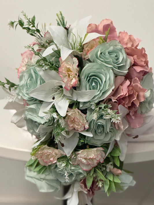 Artificial wedding bridal teardrop bouquet with blush pink hydrangeas , sage green roses and white Lilies with foliage