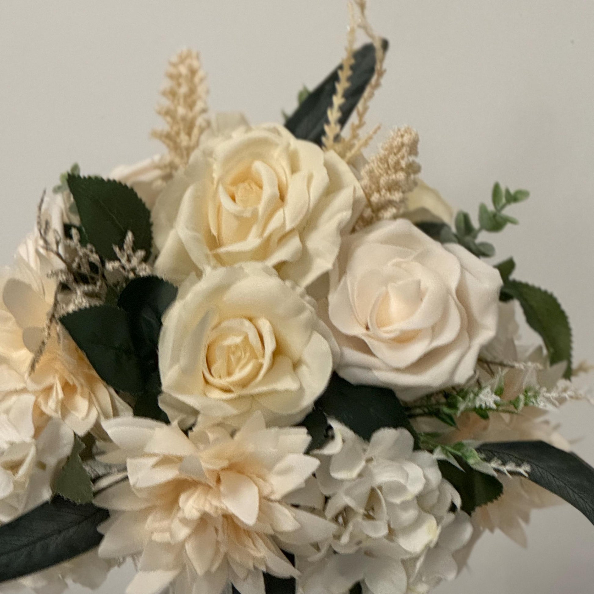 Artificial wedding bridal bouquet with all ivory flowers and foliage