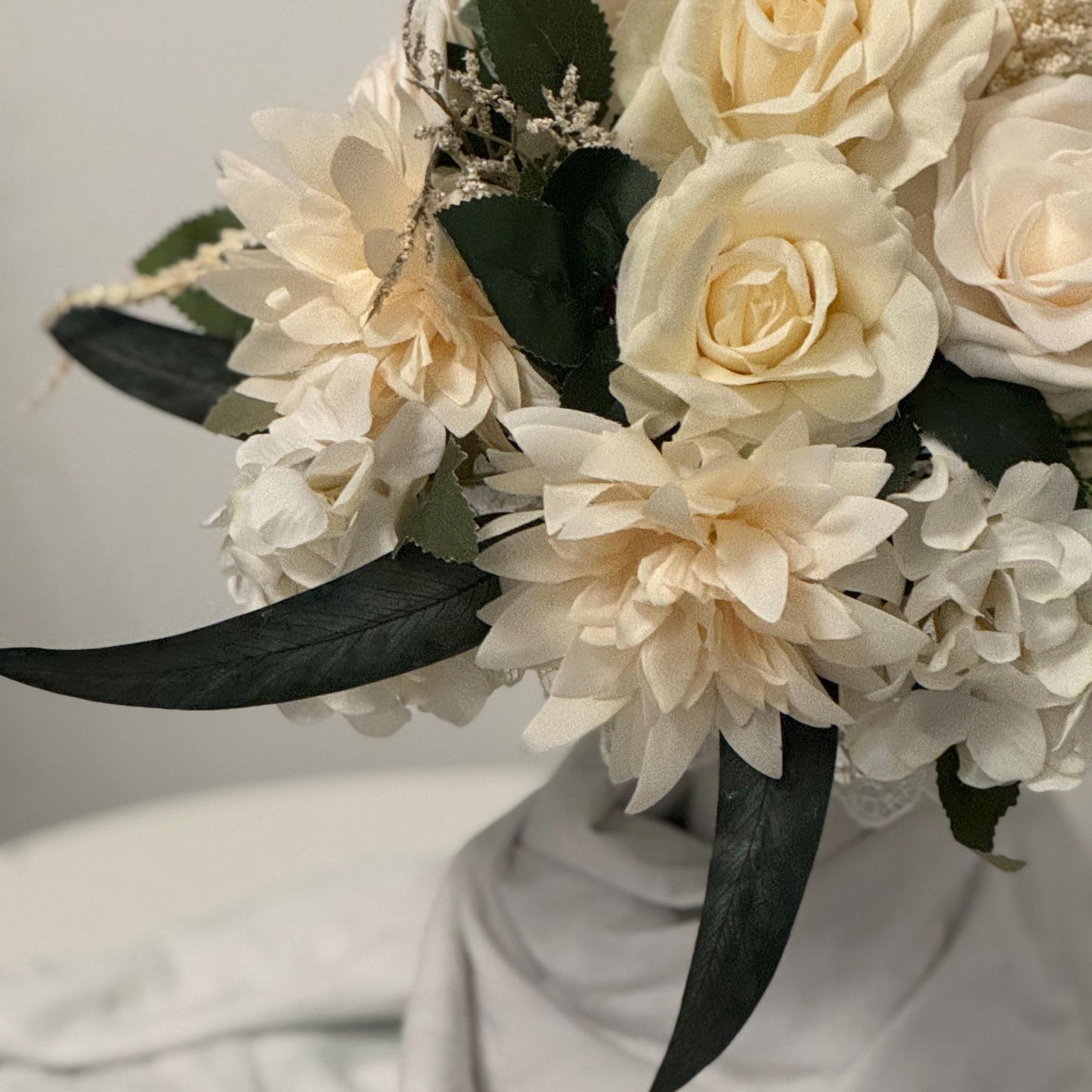 Artificial wedding bridal bouquet with all ivory flowers and foliage