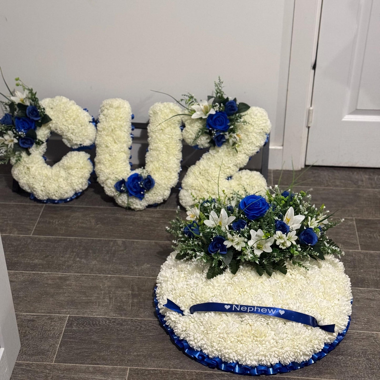 Posey 18 “ Shaped Silk Artificial Funeral Flowers Wreath/Memorial/Grave Tributes with blue roses, white lily’s and green foliage