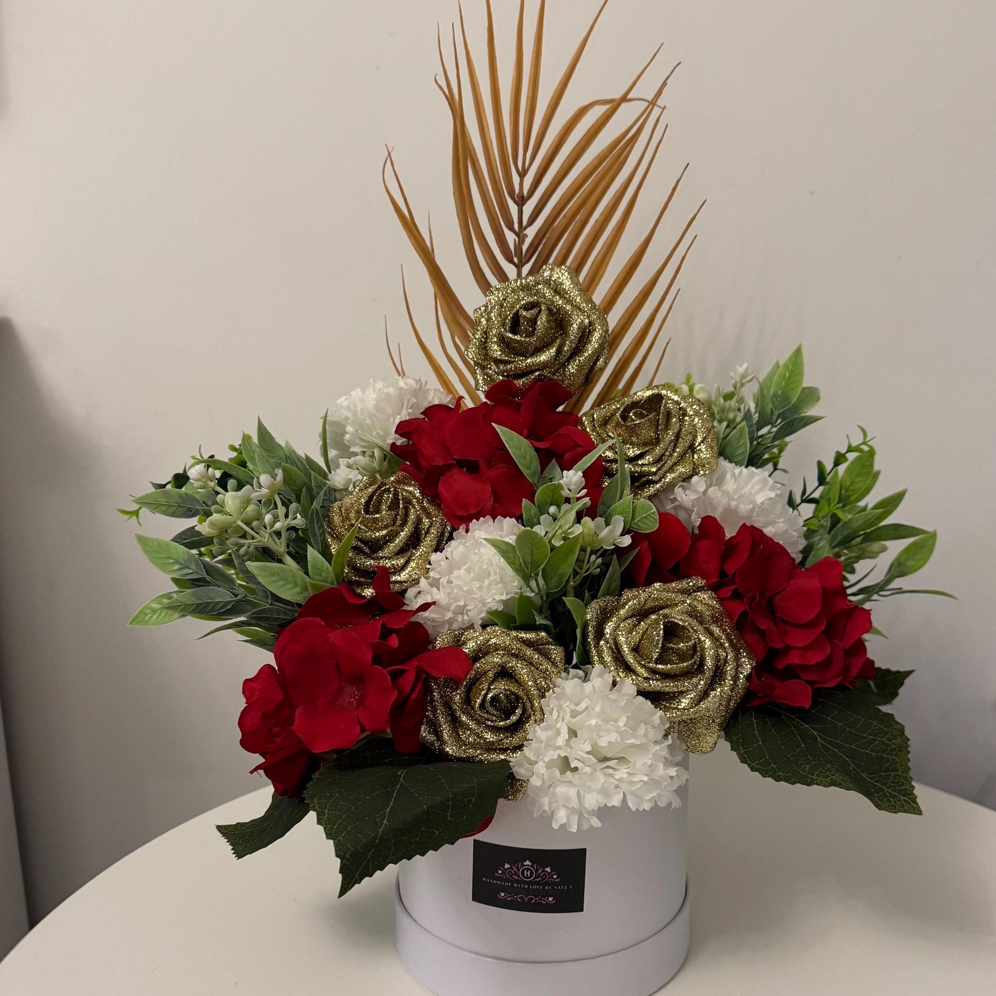 Luxury Valentines/Christmas white hat box with artificial red hydrangeas, gold glitter foam roses, ivory carnations and foliage