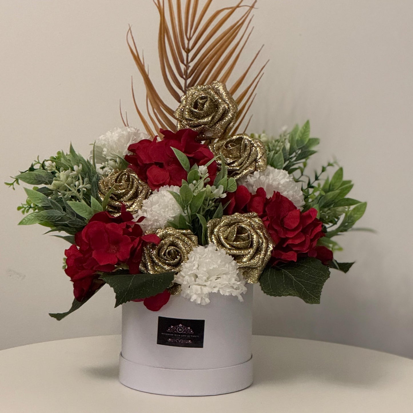 Luxury Valentines/Christmas white hat box with artificial red hydrangeas, gold glitter foam roses, ivory carnations and foliage