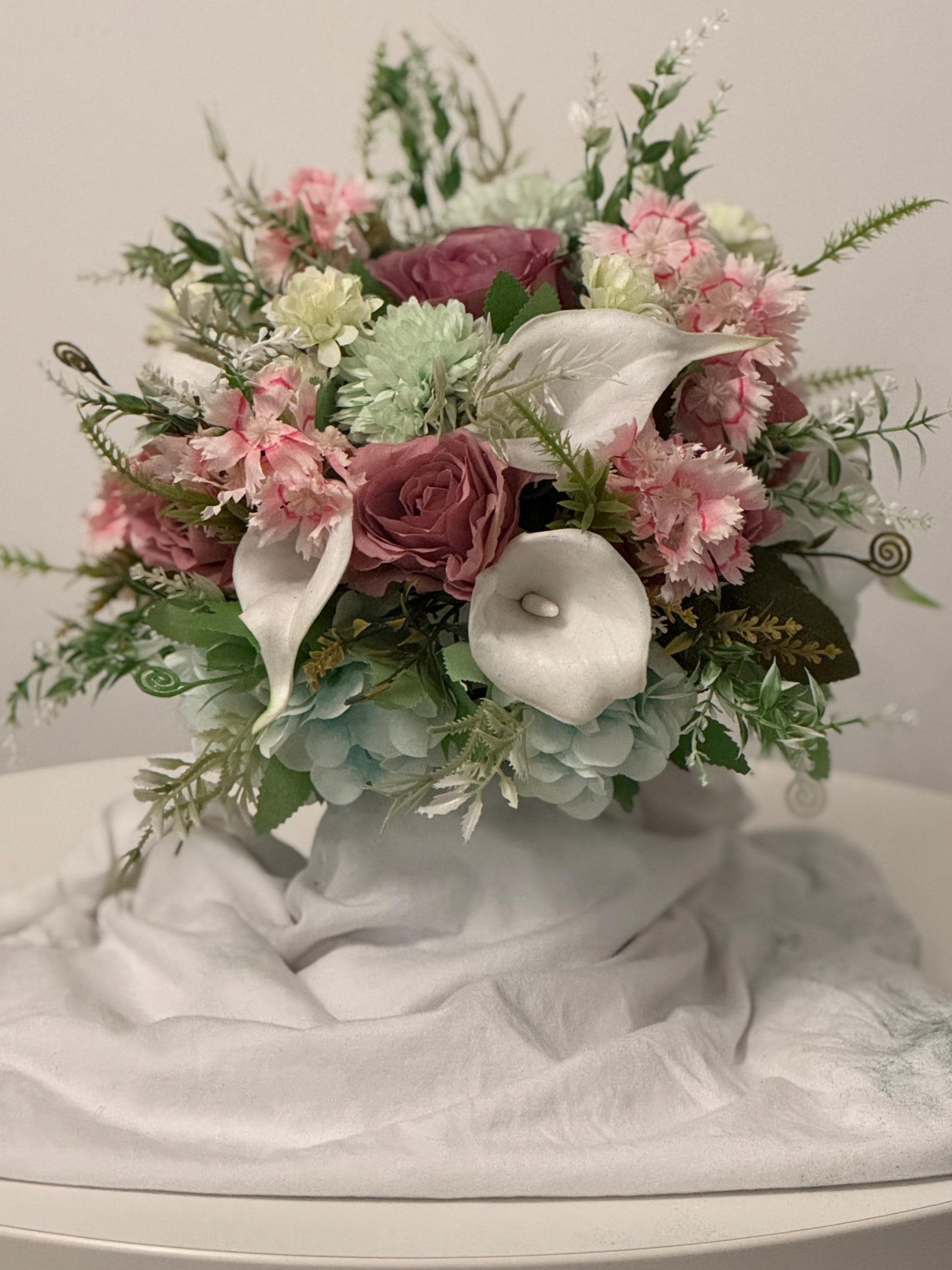 Artificial wedding bridal bouquet with blush pink roses, ivory lilies, sage green spikey chrysanthemums and foliage