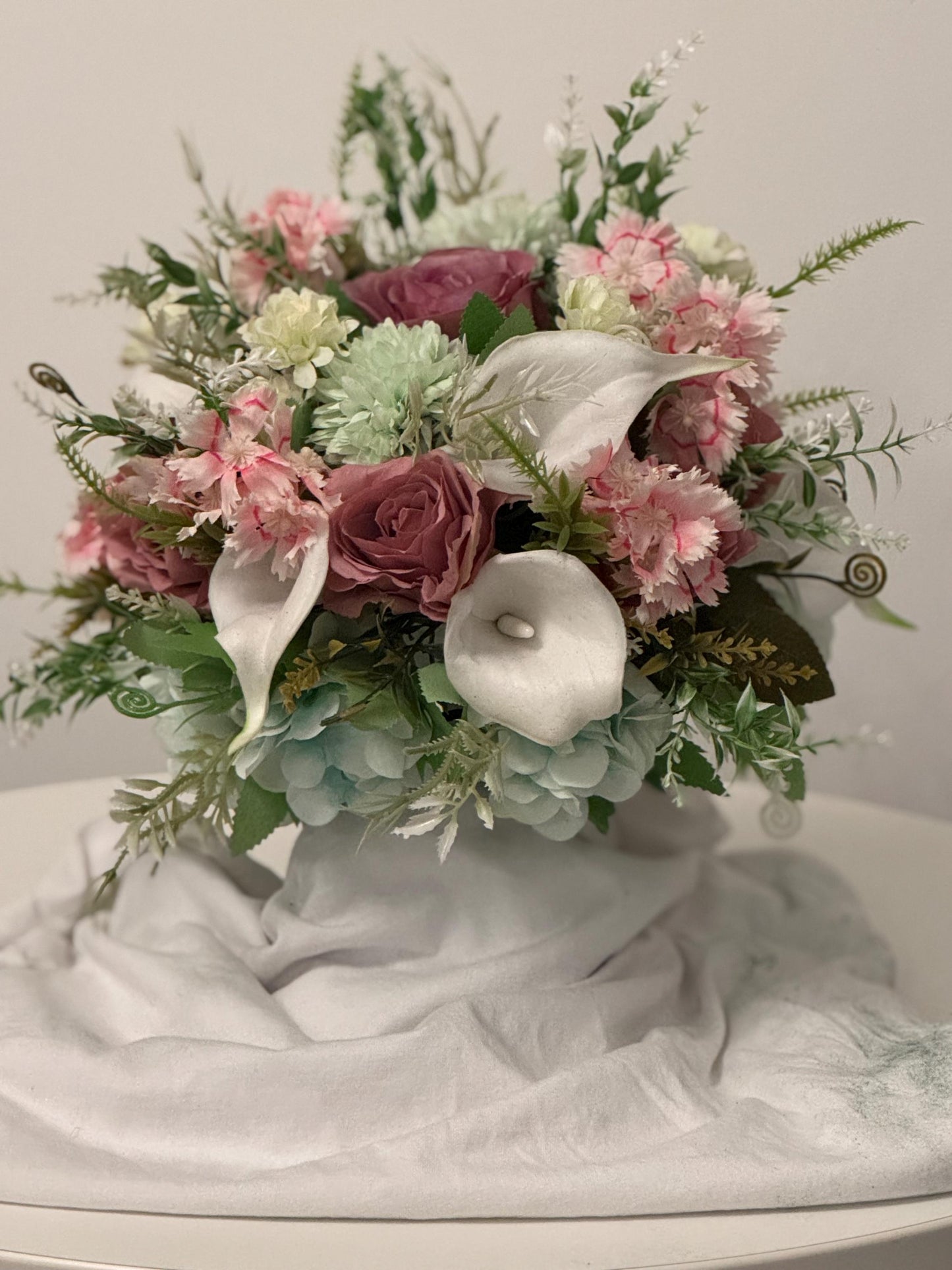 Artificial wedding bridal bouquet with blush pink roses, ivory lilies, sage green spikey chrysanthemums and foliage