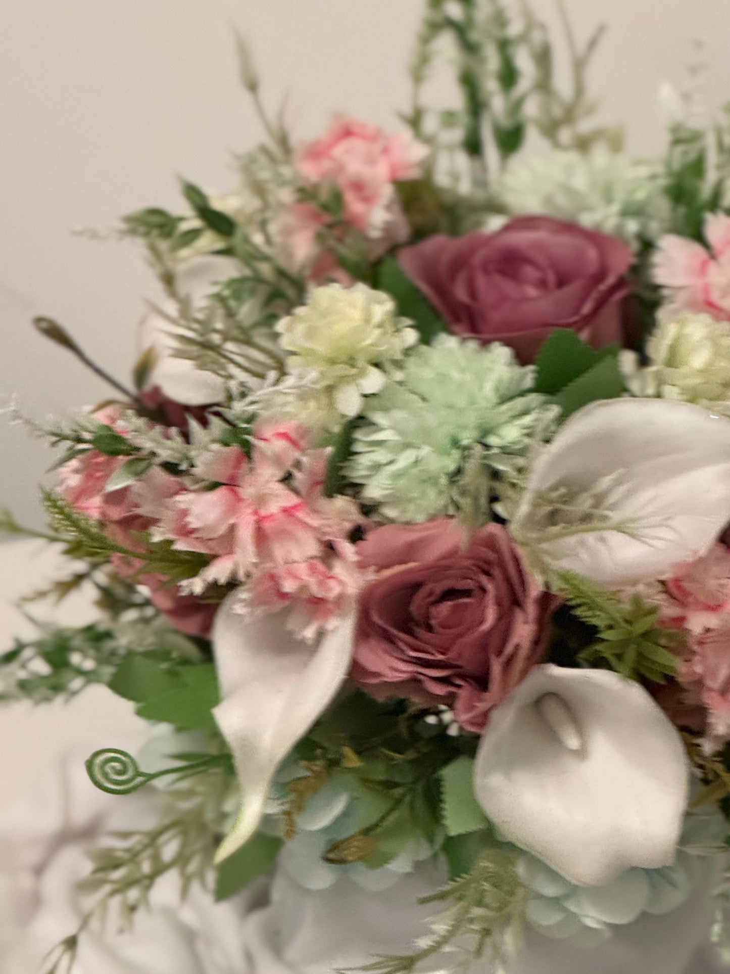 Artificial wedding bridal bouquet with blush pink roses, ivory lilies, sage green spikey chrysanthemums and foliage