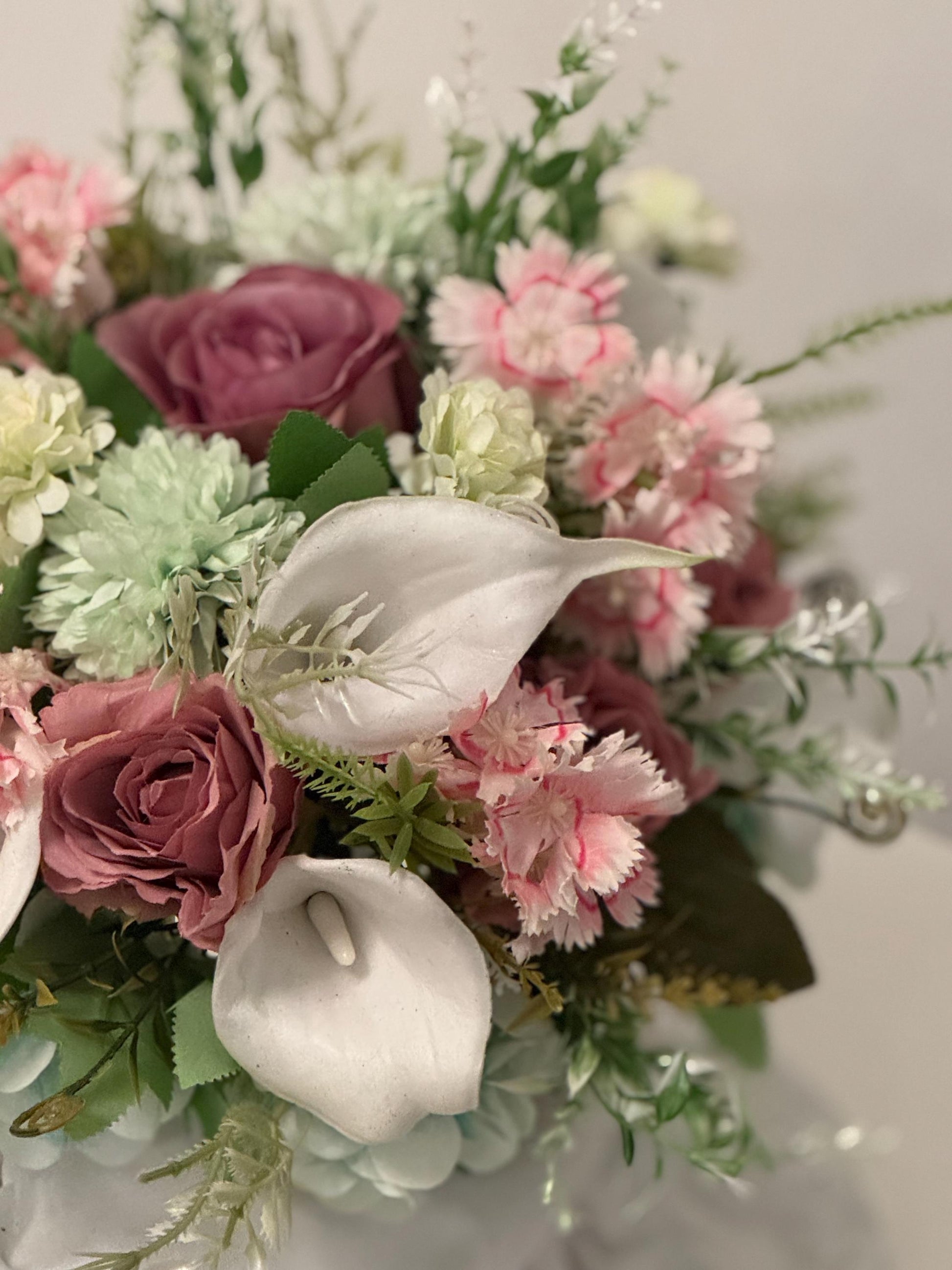 Artificial wedding bridal bouquet with blush pink roses, ivory lilies, sage green spikey chrysanthemums and foliage