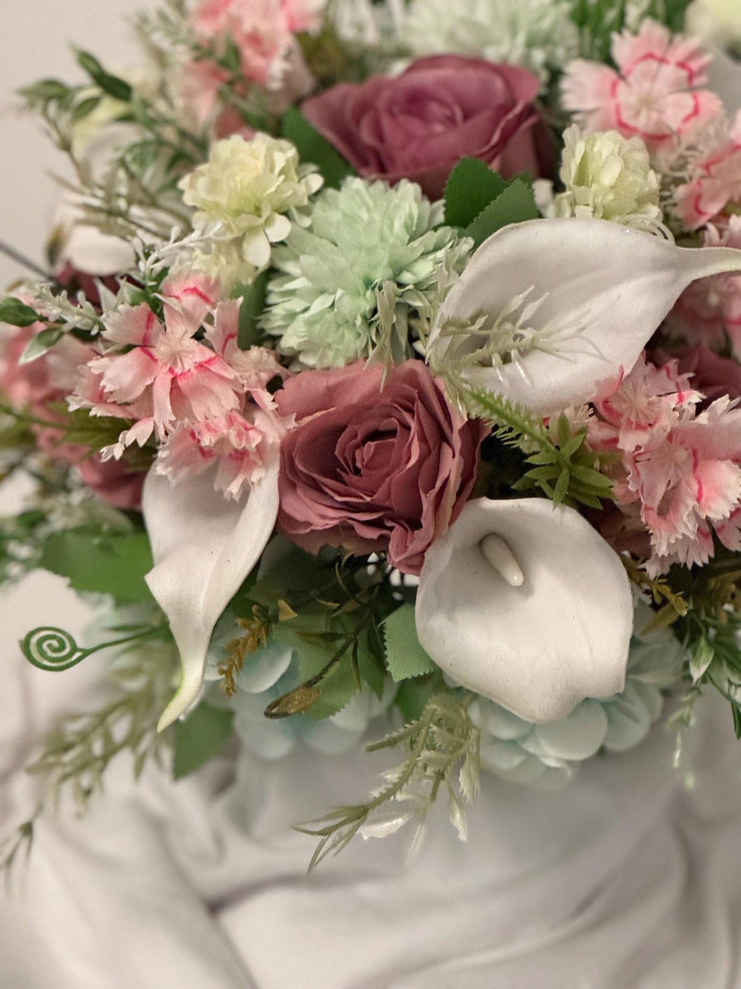 Artificial wedding bridal bouquet with blush pink roses, ivory lilies, sage green spikey chrysanthemums and foliage