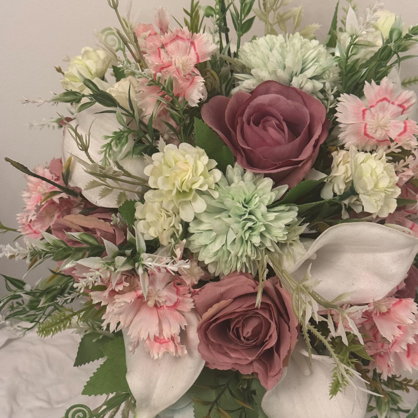 Artificial wedding bridal bouquet with blush pink roses, ivory lilies, sage green spikey chrysanthemums and foliage