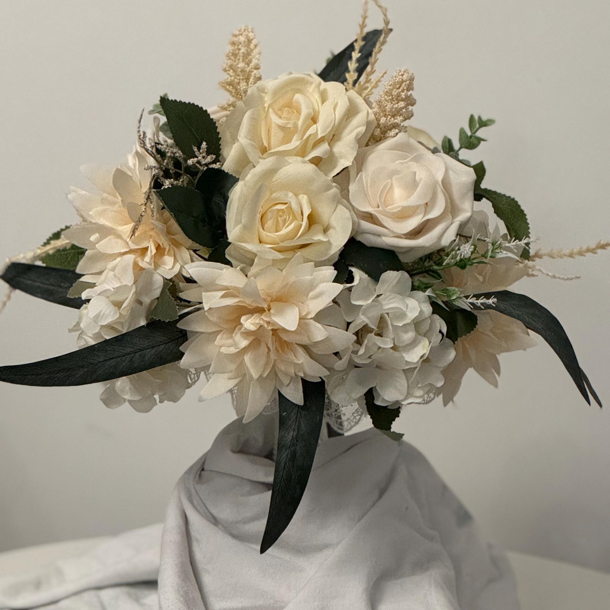 Artificial wedding bridal bouquet with all ivory flowers and foliage