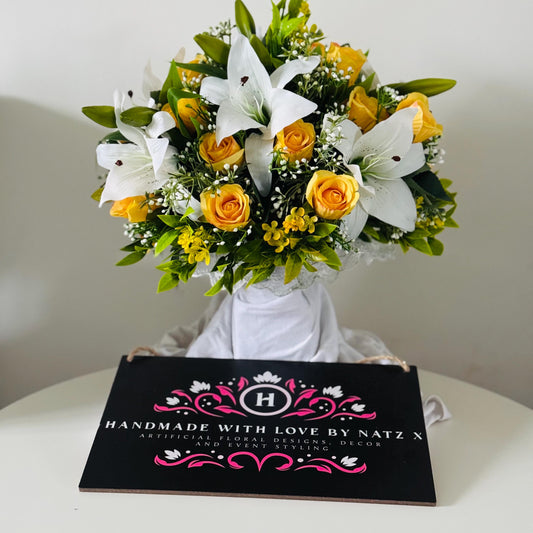 Artificial wedding bridal bouquet with white lilys, yellow rosebuds and foliage