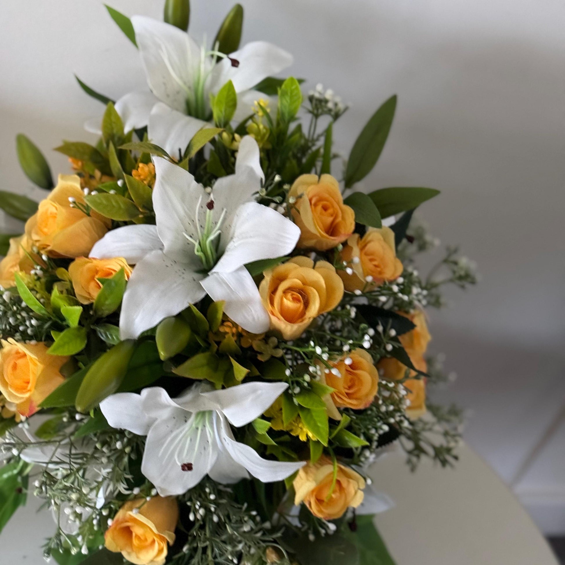 Artificial wedding bridal teardrop bouquet with white Lilys, yellow rosebuds and foliage. Ideal for spring/summer weddings