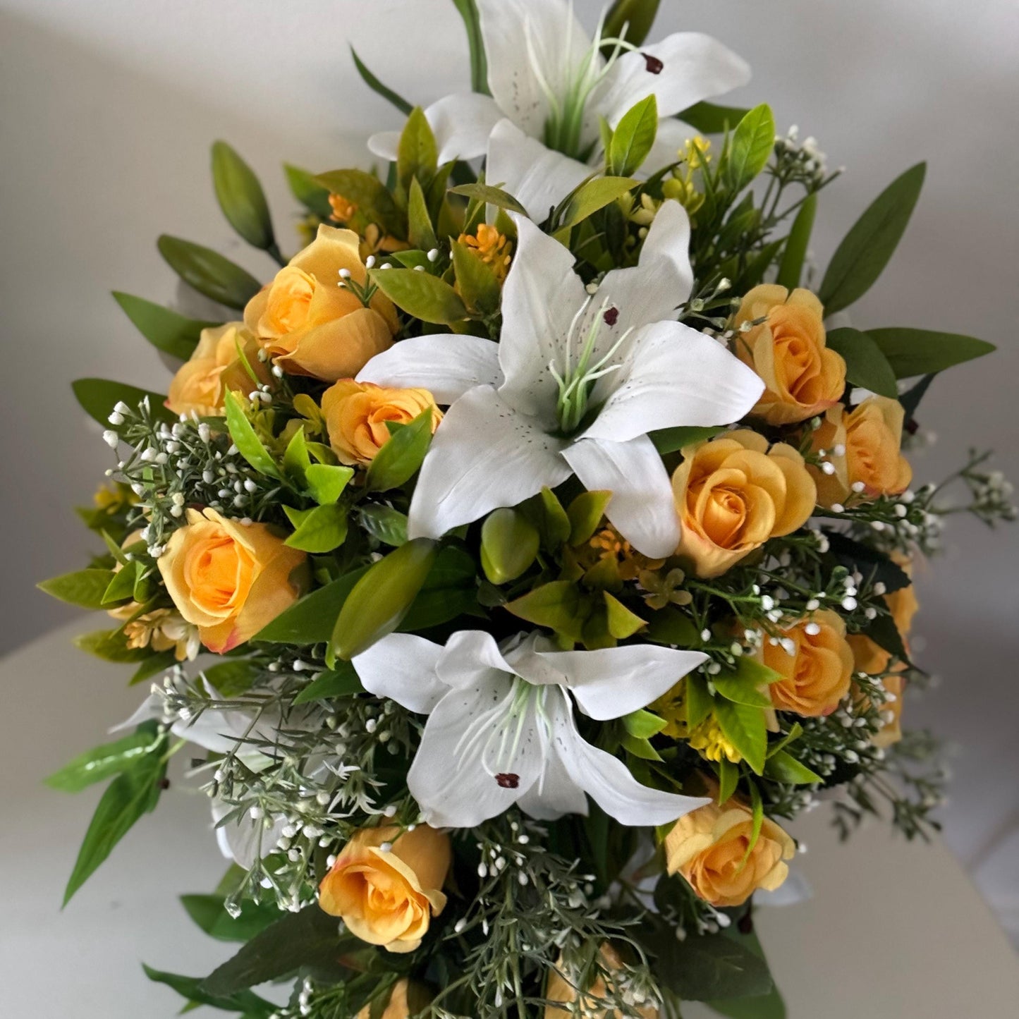 Artificial wedding bridal teardrop bouquet with white Lilys, yellow rosebuds and foliage. Ideal for spring/summer weddings