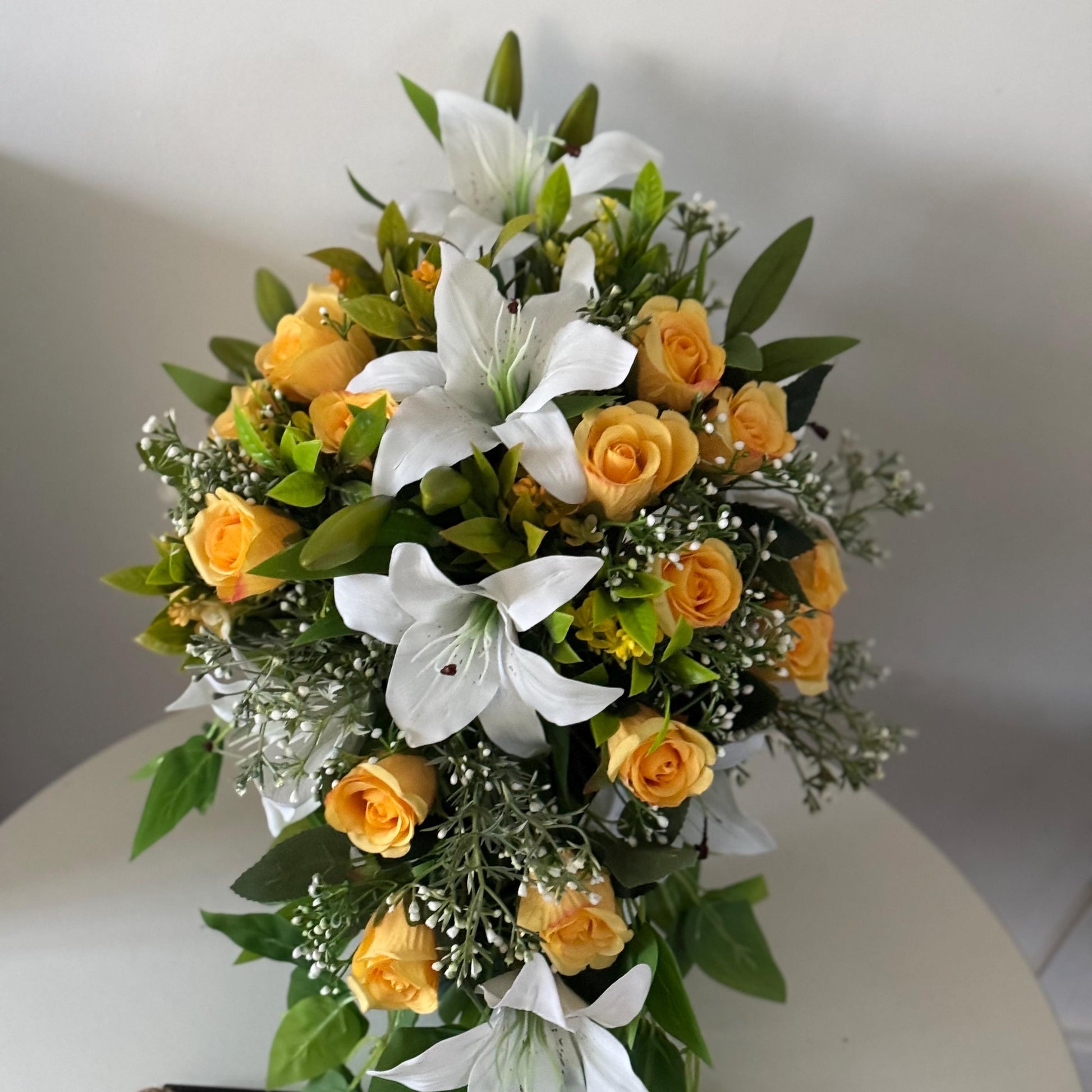 Artificial wedding bridal teardrop bouquet with white Lilys, yellow rosebuds and foliage. Ideal for spring/summer weddings