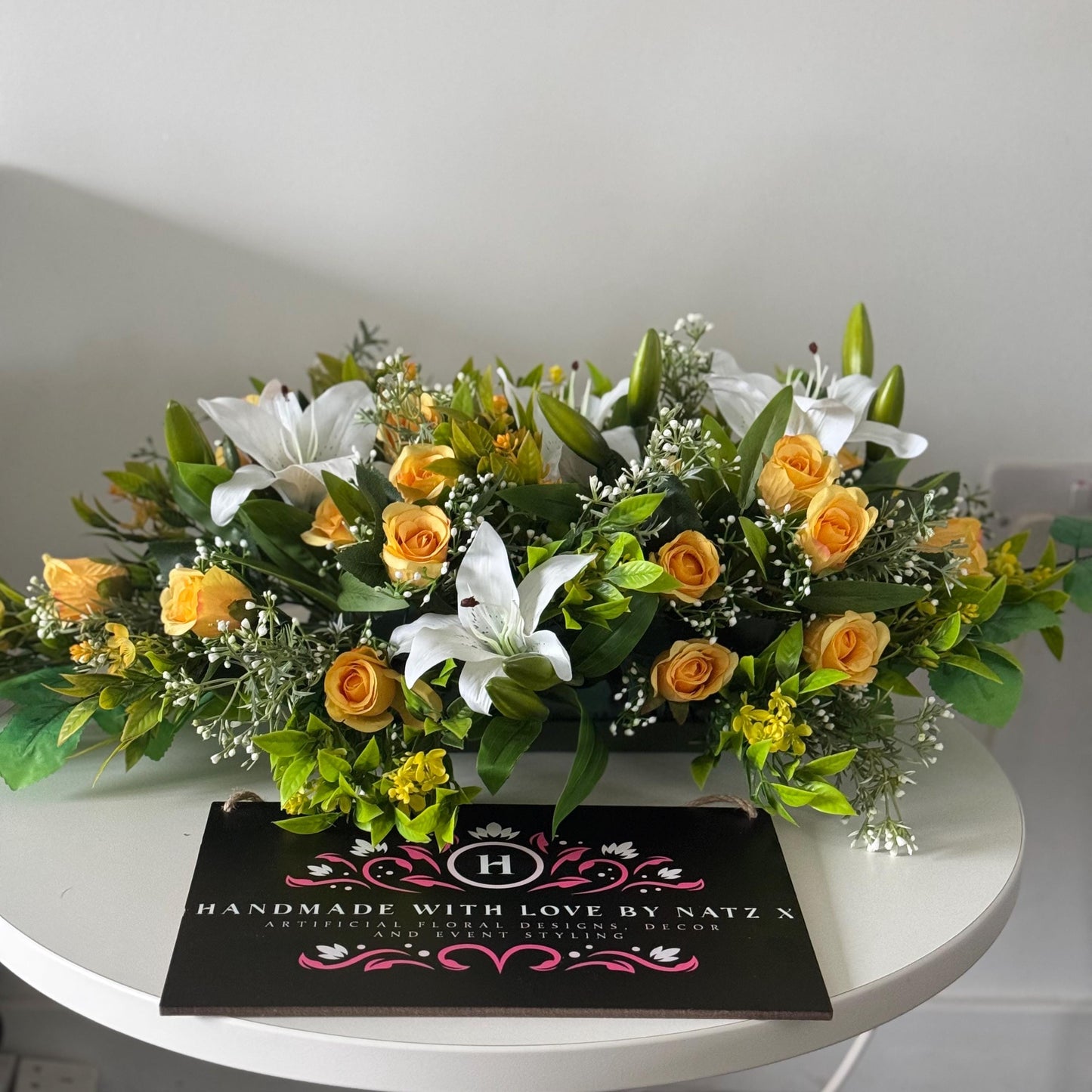 Artificial wedding table centre piece, with white Lilys, yellow rosebuds and foliage. Ideal for spring/summer weddings