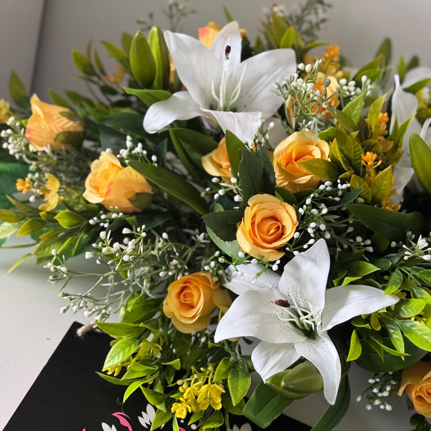 Artificial wedding table centre piece, with white Lilys, yellow rosebuds and foliage. Ideal for spring/summer weddings