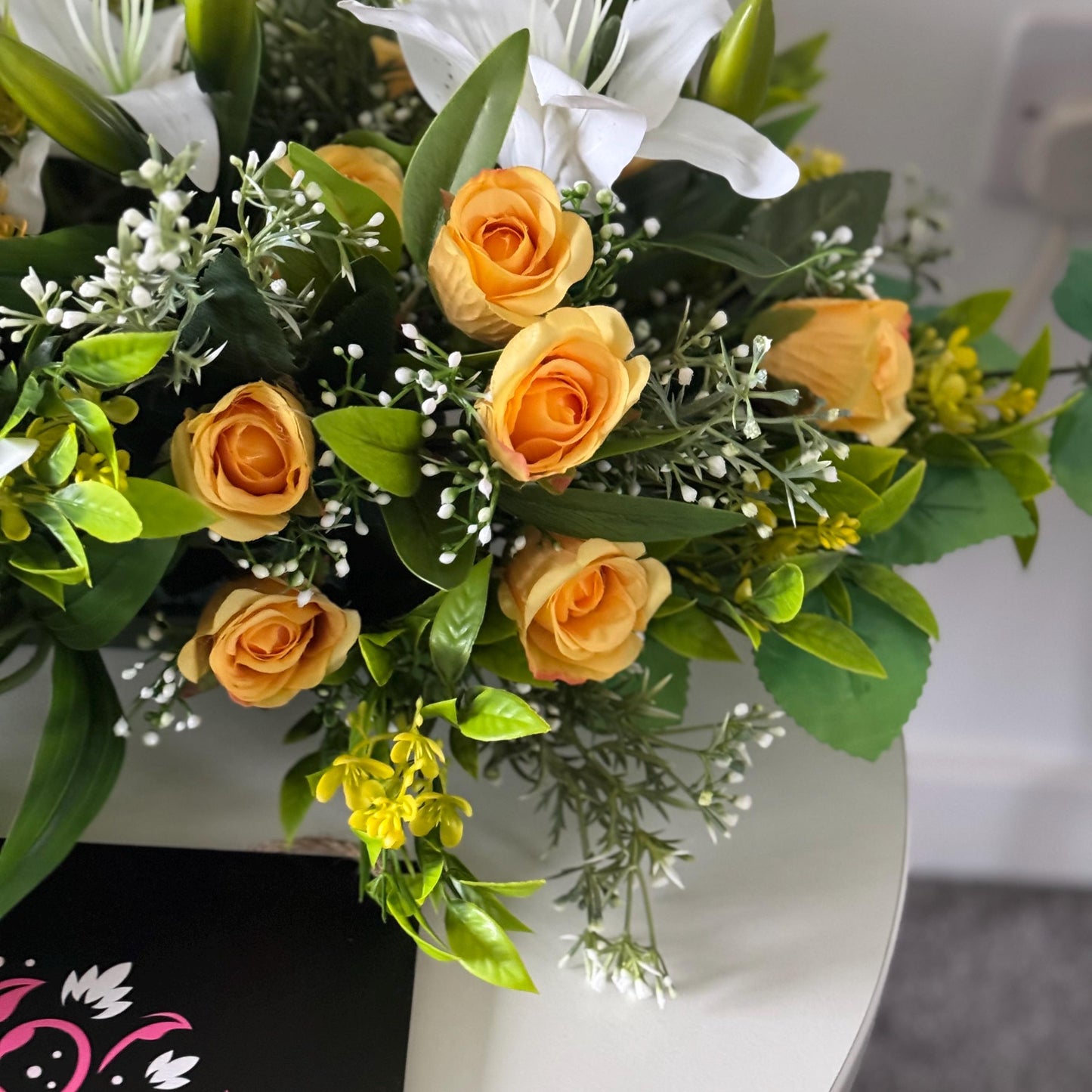 Artificial wedding table centre piece, with white Lilys, yellow rosebuds and foliage. Ideal for spring/summer weddings