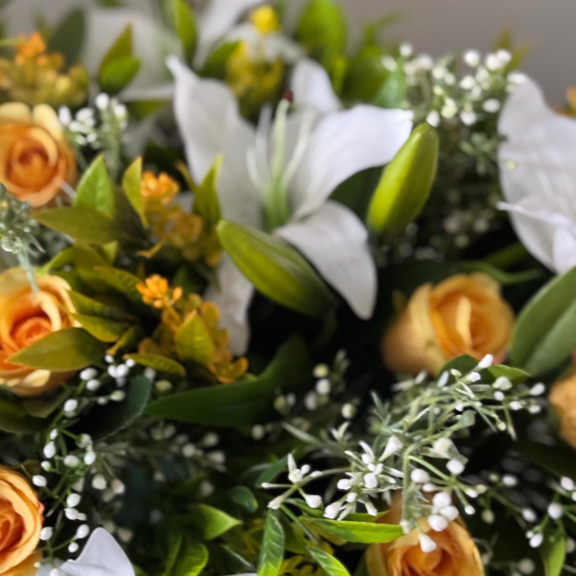 Artificial wedding table centre piece, with white Lilys, yellow rosebuds and foliage. Ideal for spring/summer weddings