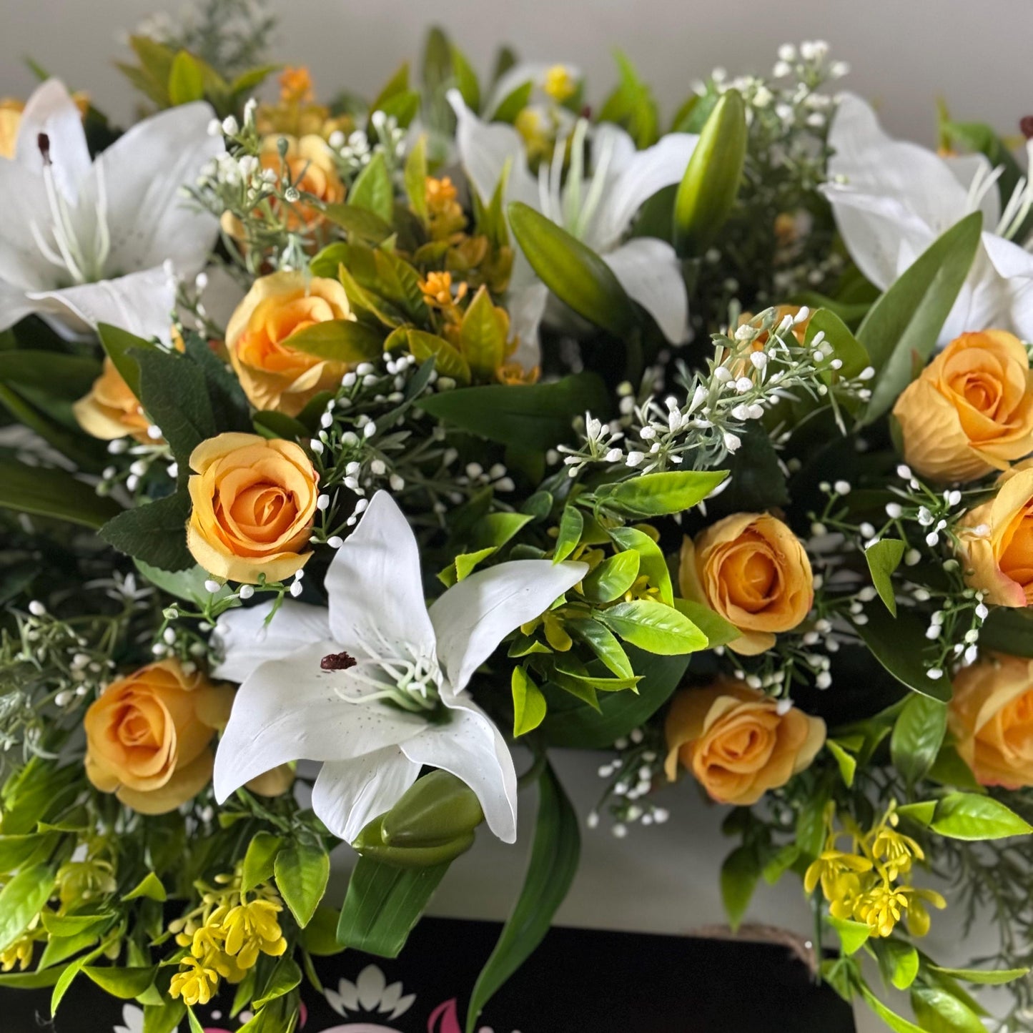 Artificial wedding table centre piece, with white Lilys, yellow rosebuds and foliage. Ideal for spring/summer weddings